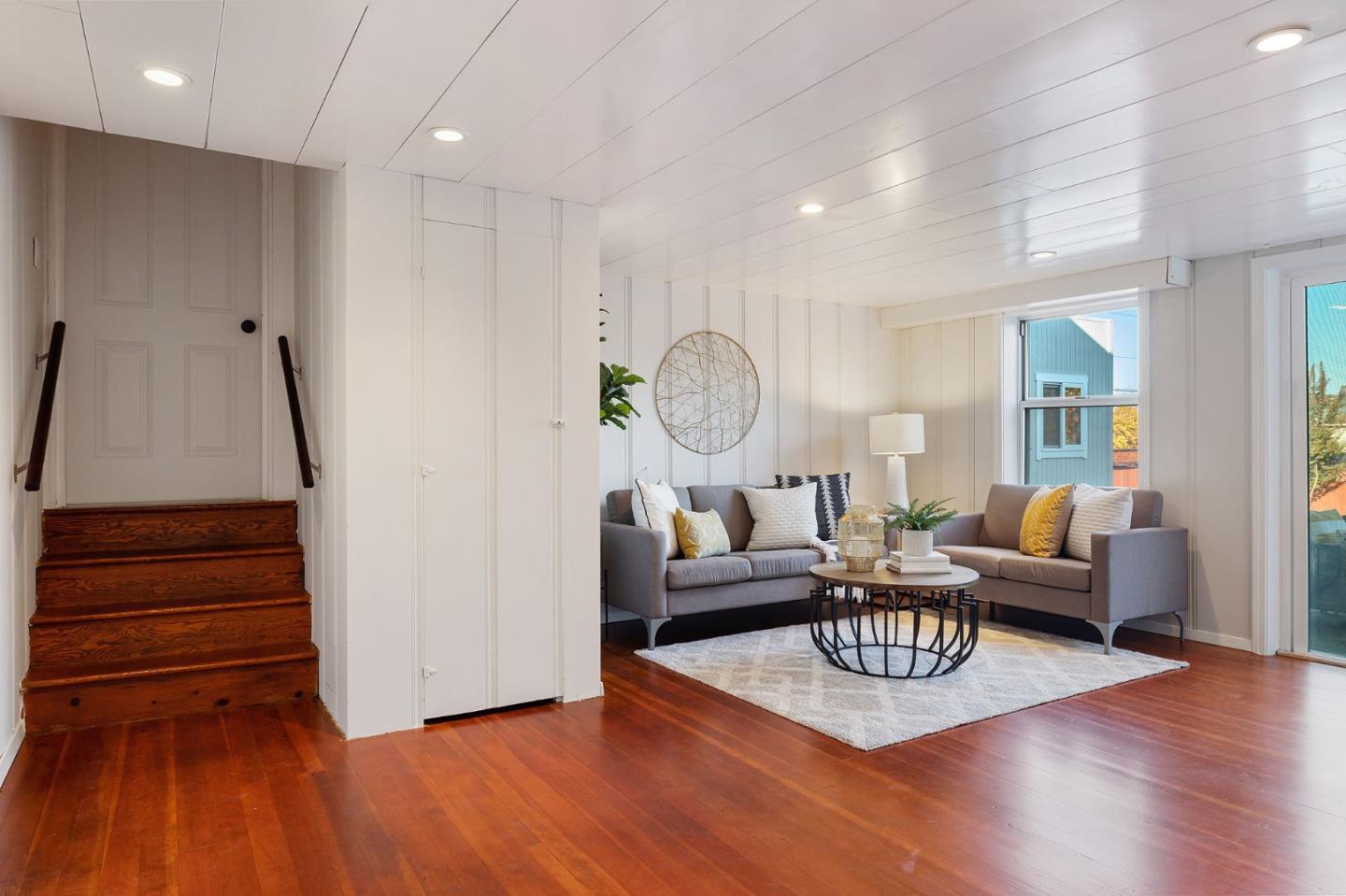 194 Willow Avenue Millbrae, CA 94030 - Photo 39 of 76 a living room with furniture a wooden floor and a clock