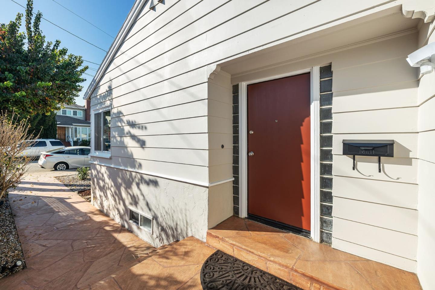 194 Willow Avenue Millbrae, CA 94030 - Photo 76 of 76 a view of a house with a door and wooden bench