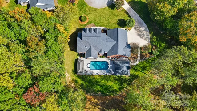 an aerial view of a house with a yard basket ball court and outdoor seating