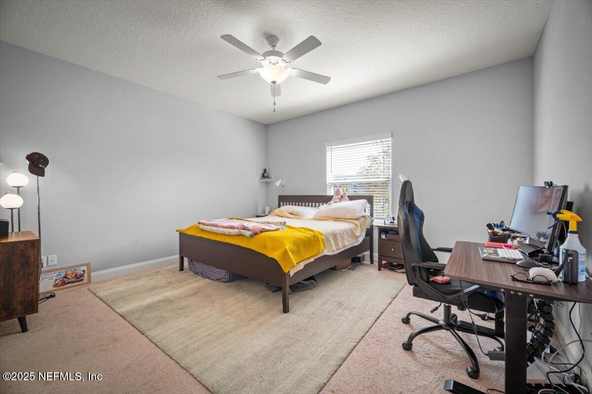 141 Killarney Avenue St. Johns, FL 32259 - Photo 15 of 33 a bedroom with a bed window and chair