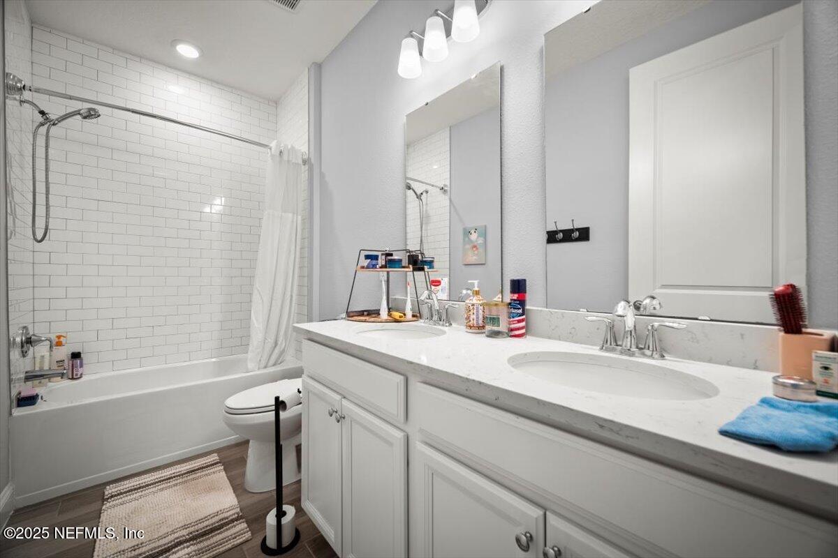 141 Killarney Avenue St. Johns, FL 32259 - Photo 17 of 33 a bathroom with a sink double vanity granite tub shower and a mirror