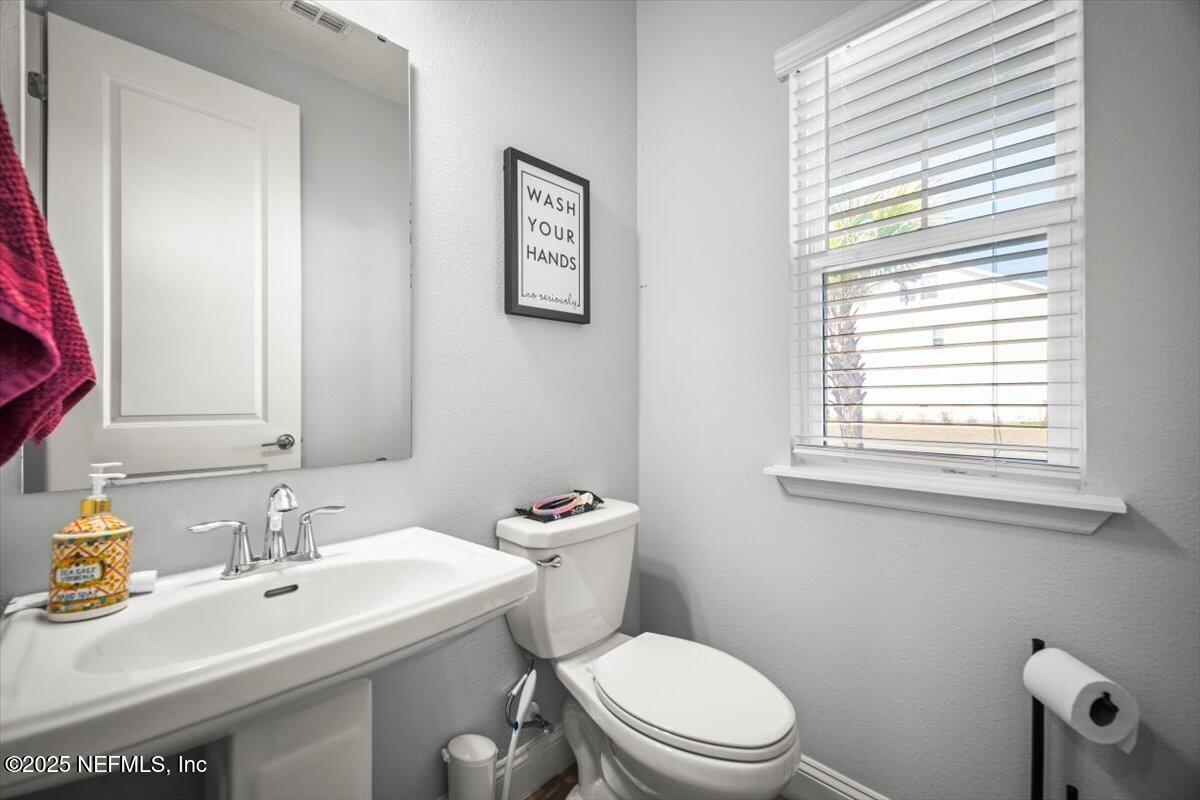 141 Killarney Avenue St. Johns, FL 32259 - Photo 26 of 33 a bathroom with a sink a toilet and a window