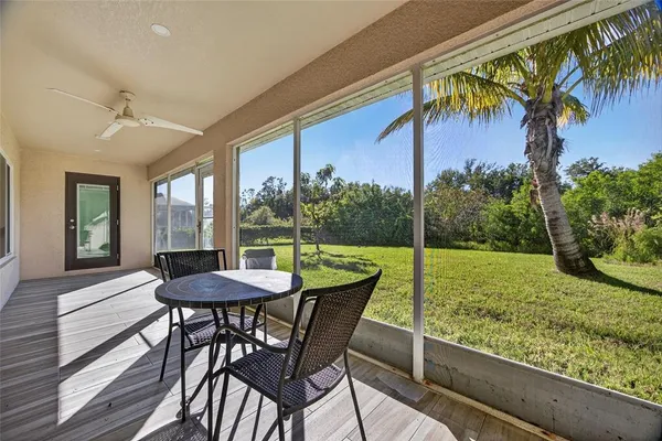 a view of a porch with furniture and a yard