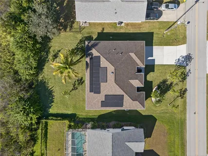 an aerial view of a house with a yard