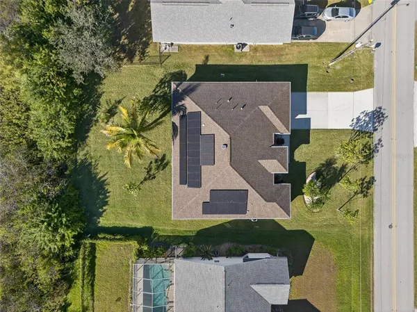 an aerial view of a house with a yard