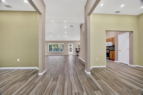 wooden floor in an empty room with a window