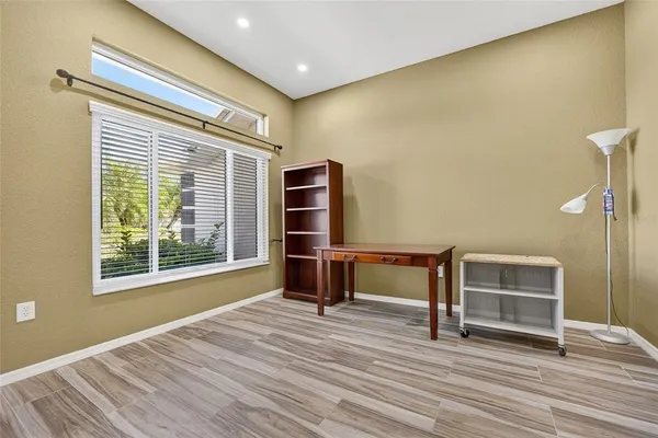 a view of a room with wooden floor and furniture