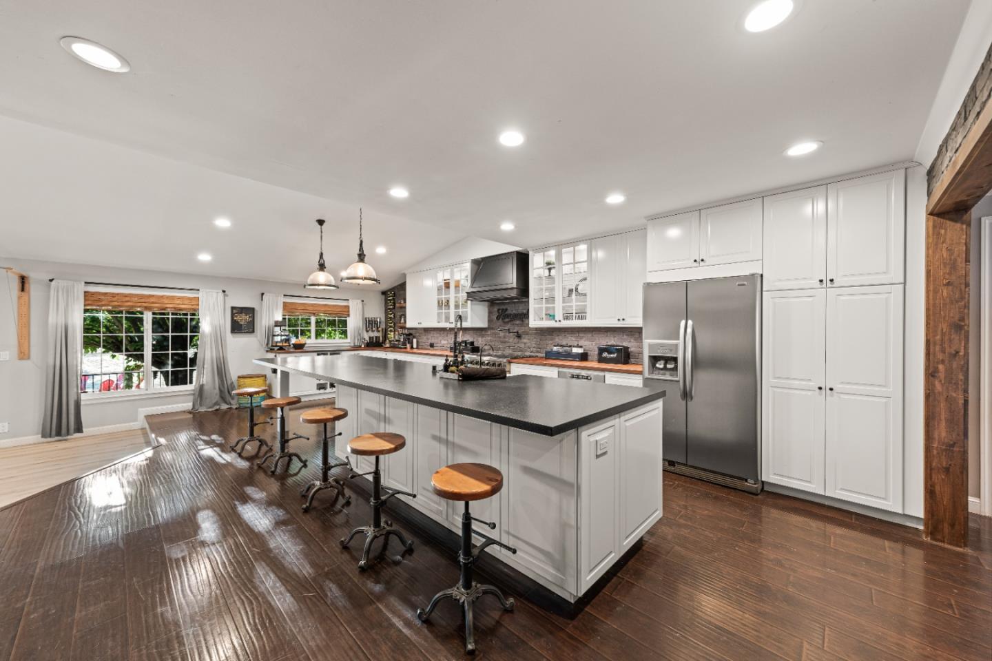 9735 New Avenue Gilroy, CA 95020 - Photo 2 of 52 a kitchen with stainless steel appliances granite countertop a refrigerator a stove a sink a dining table and chairs with wooden floor