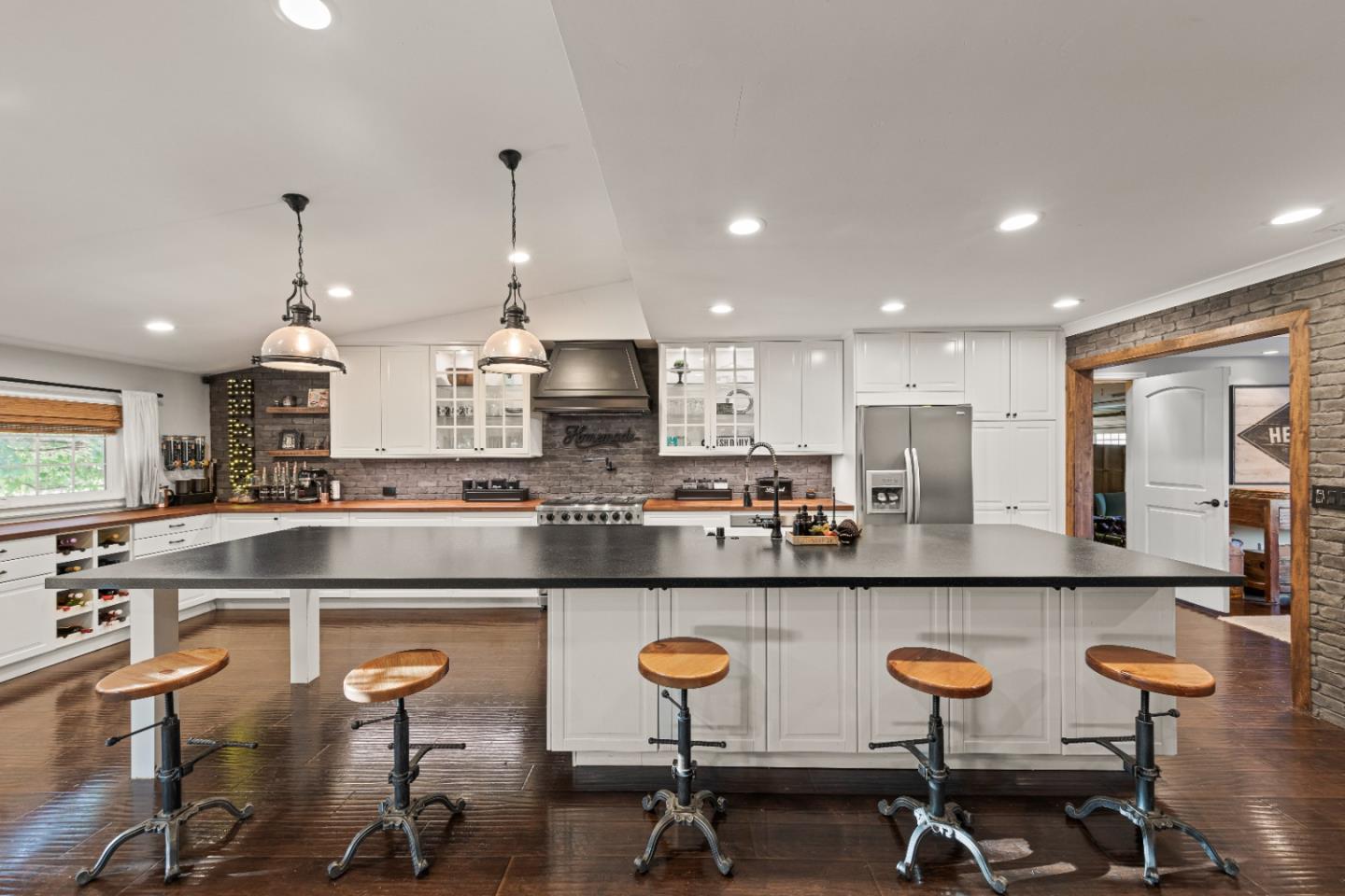 9735 New Avenue Gilroy, CA 95020 - Photo 3 of 52 a kitchen with kitchen island granite countertop wooden cabinets and chairs