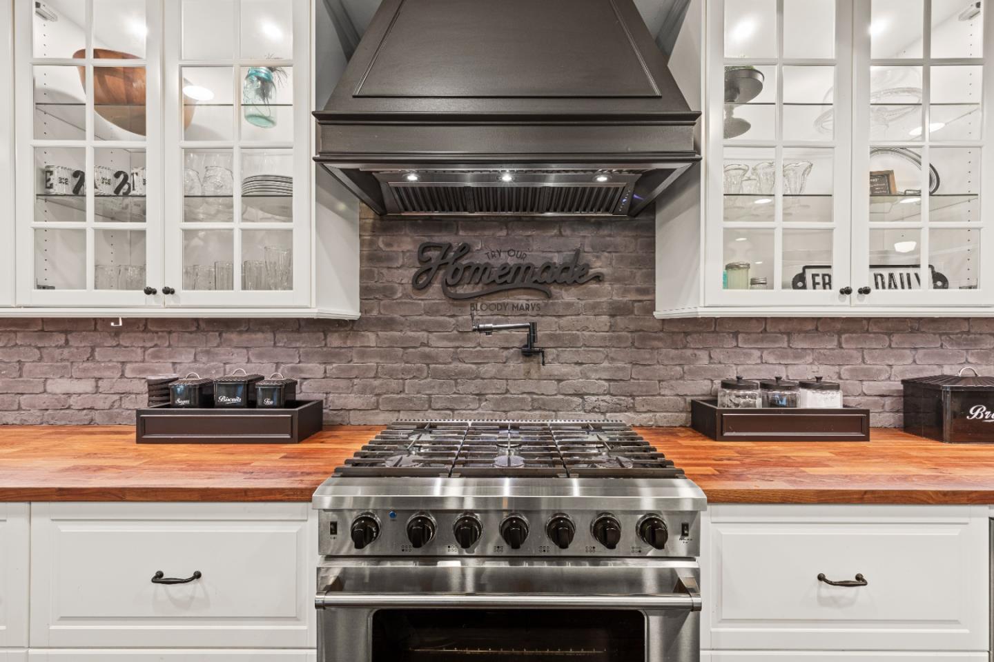 9735 New Avenue Gilroy, CA 95020 - Photo 4 of 52 a stove top oven sitting inside of a kitchen and granite counter tops
