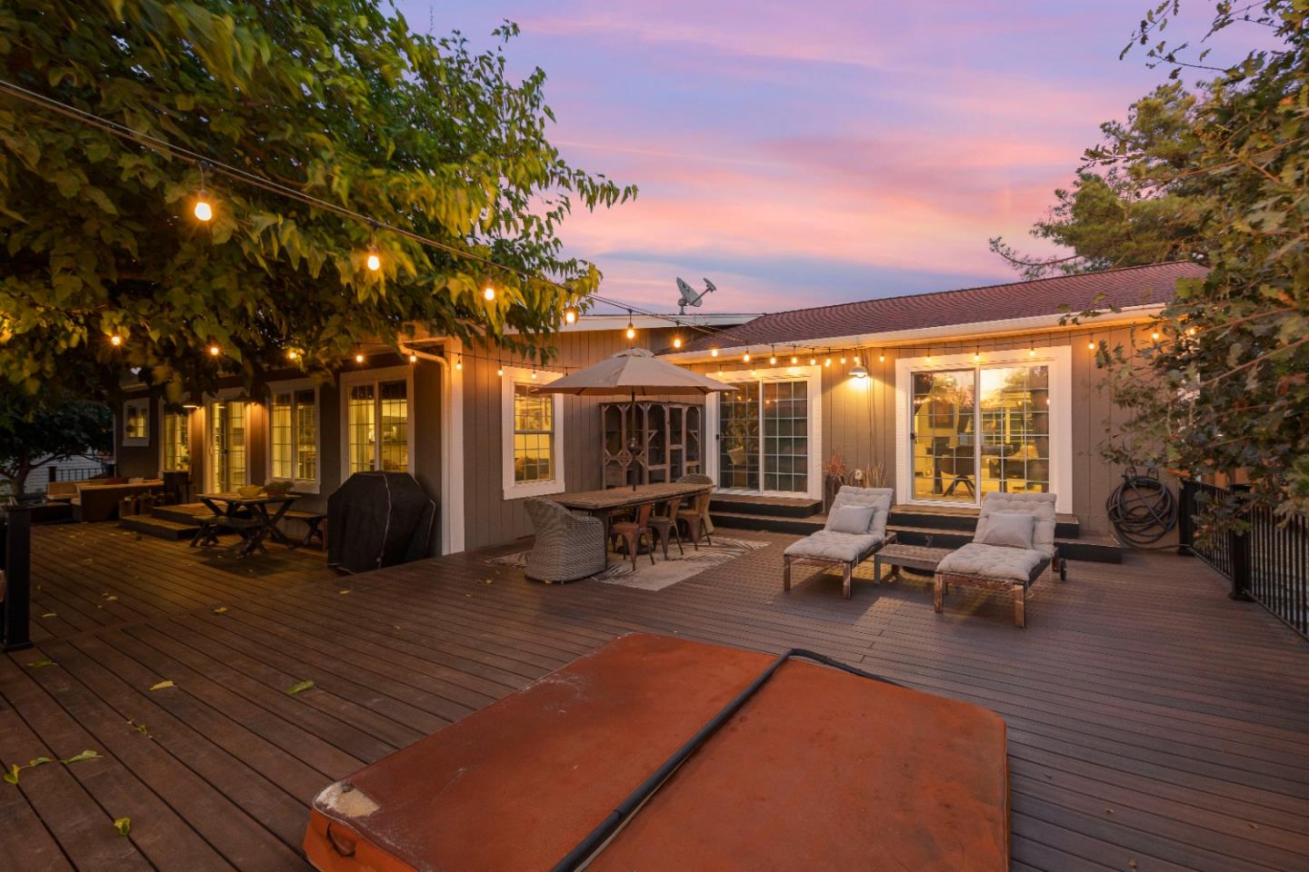 9735 New Avenue Gilroy, CA 95020 - Photo 43 of 52 a view of a patio with dining table and chairs with wooden floor and fence