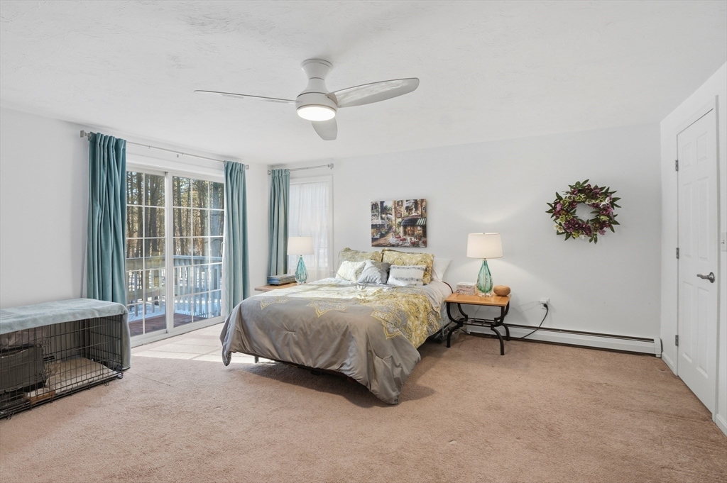 17 Longley Road Shirley, MA 01464 - Photo 11 of 33 a bedroom with a bed and a chandelier