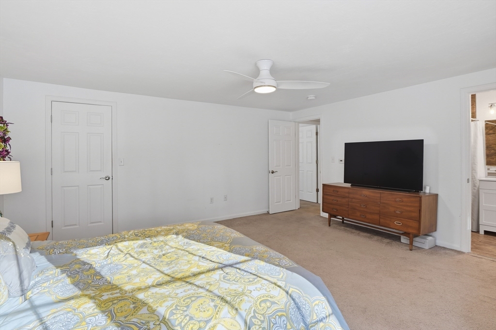 17 Longley Road Shirley, MA 01464 - Photo 12 of 33 a bedroom with a bed and a flat screen tv