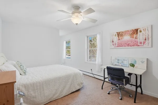 a bedroom with a bed and a desk