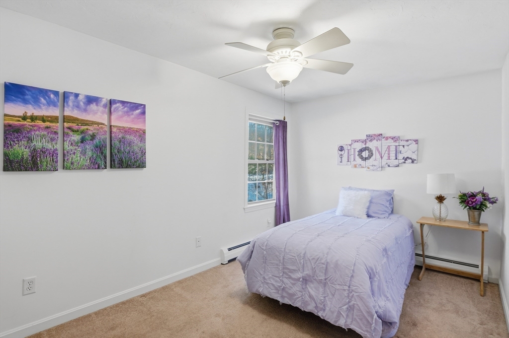 17 Longley Road Shirley, MA 01464 - Photo 19 of 33 a bedroom with a large bed and a chandelier