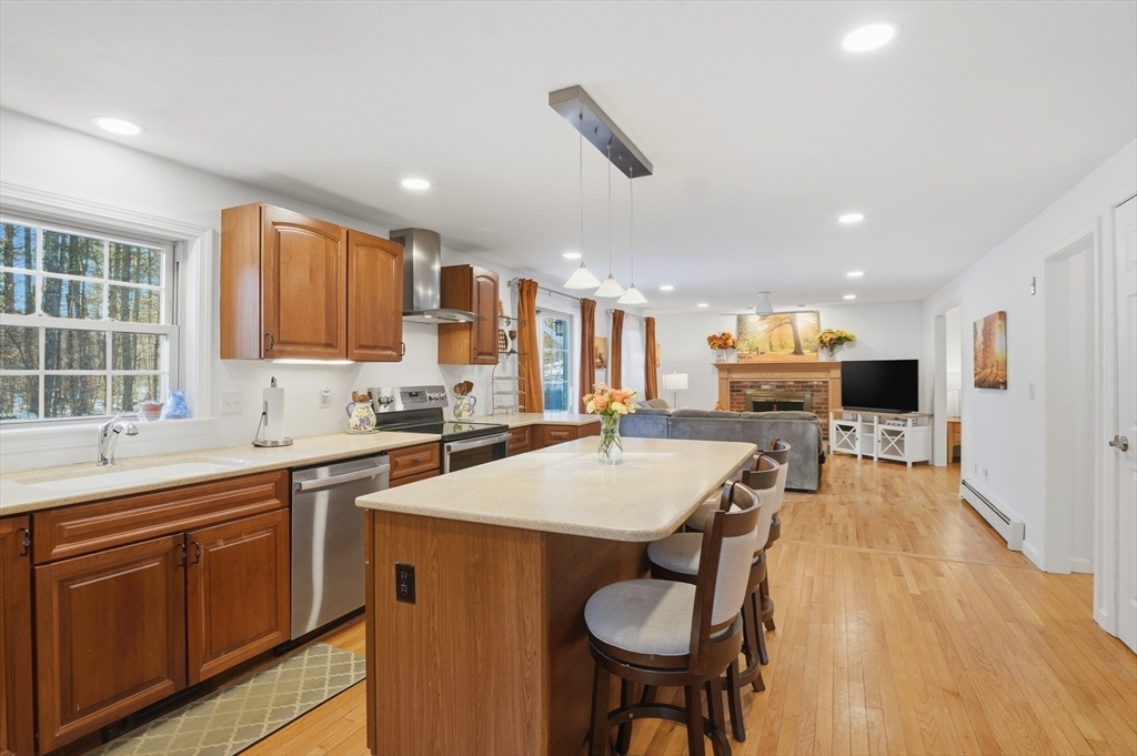 17 Longley Road Shirley, MA 01464 - Photo 7 of 33 a large kitchen with kitchen island a sink table and chairs