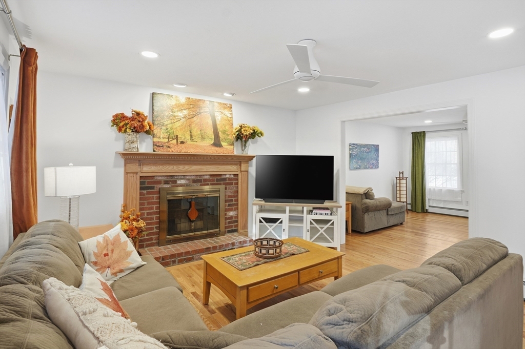 17 Longley Road Shirley, MA 01464 - Photo 8 of 33 a living room with furniture a flat screen tv and a fireplace