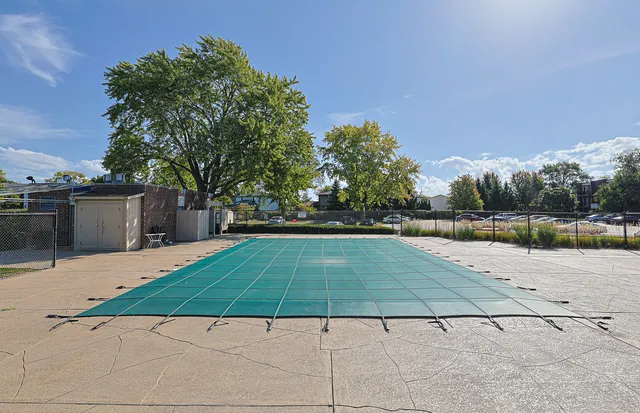a view of a swimming pool with an outdoor seating and a garden
