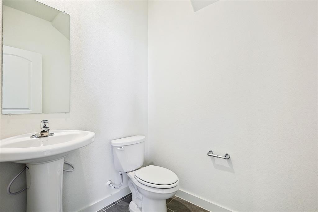 213 Patton Lane Venus, TX 76084 - Photo 7 of 30 Bathroom featuring baseboards and dark tile patterned flooring