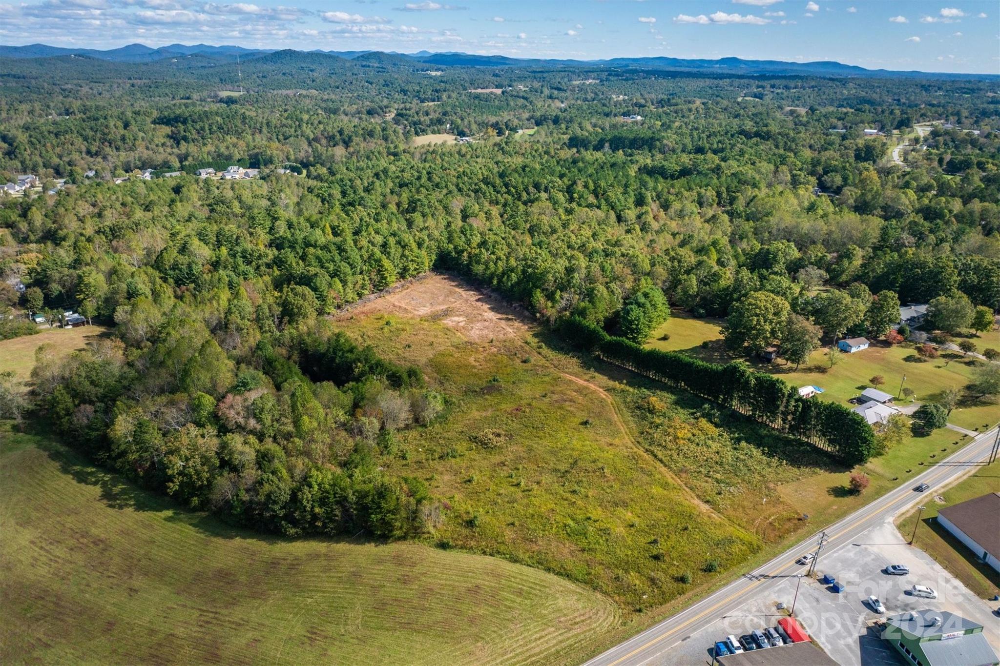 4054 Lower Cedar Valley Road Hudson, NC 28638 - Photo 10 of 15 a view of a forest with a lake