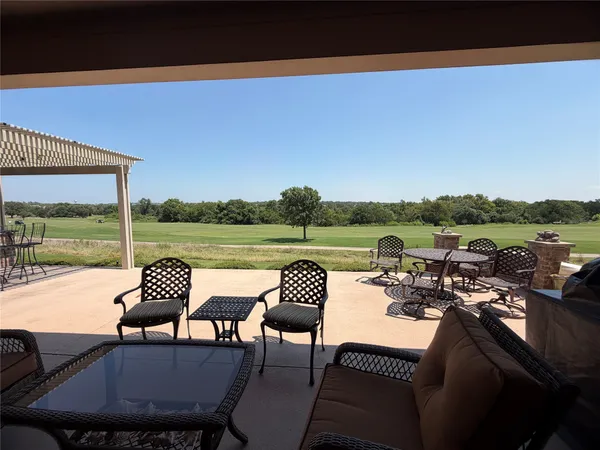 a view of a chairs and table in patio