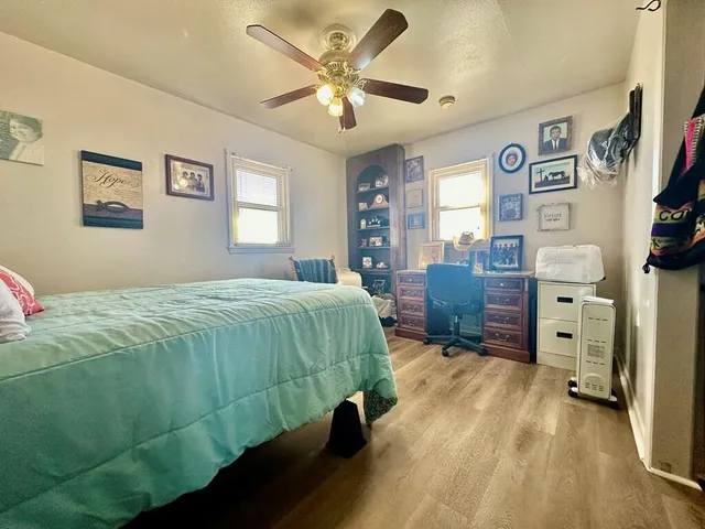 a bedroom with a bed and a desk