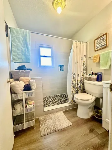 a bathroom with a toilet and a shower