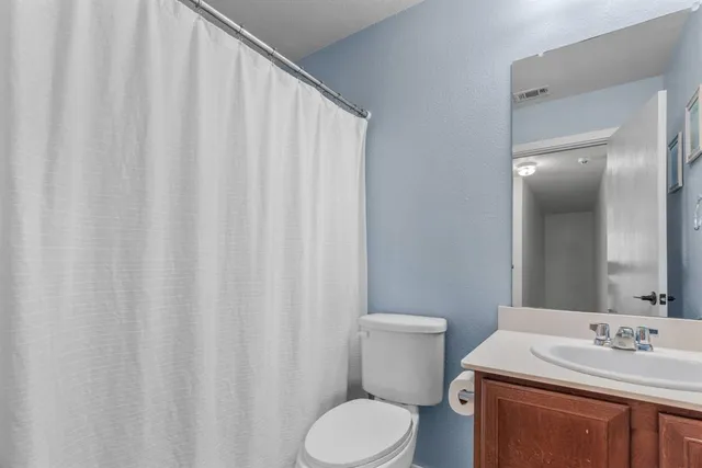 a bathroom with a toilet a sink and a mirror