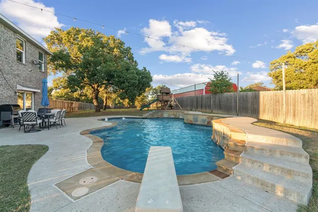 a view of a swimming pool with a patio