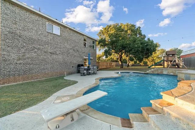 a view of a patio with swimming pool