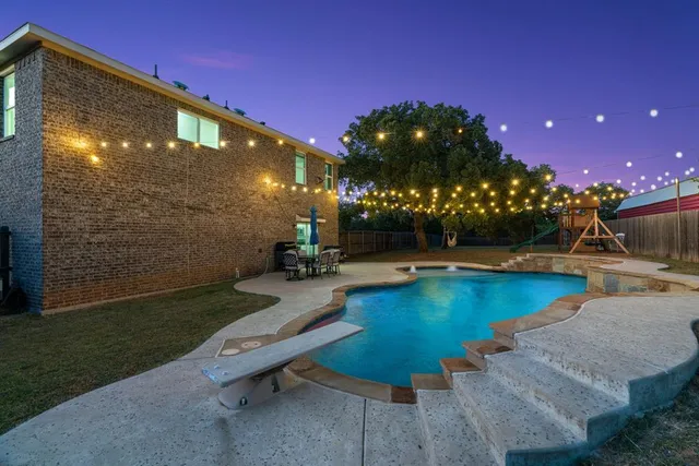 a view of a swimming pool with a patio