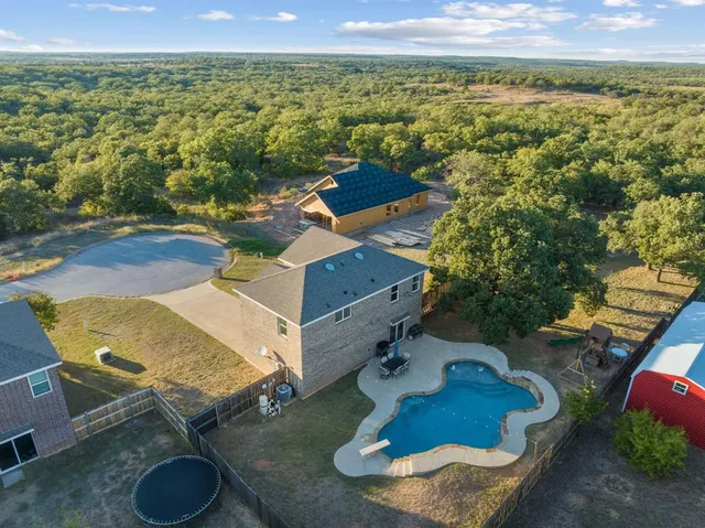 an aerial view of a house with yard