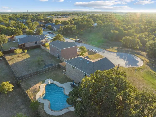 an aerial view of residential houses with outdoor space