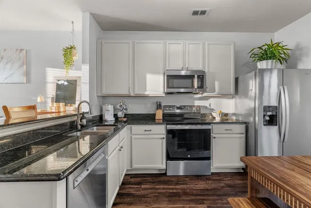 a kitchen with a sink stove and refrigerator