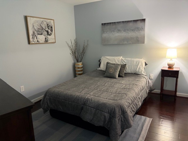 5925 Almeda Road, Unit 11513 Houston, TX 77004 - Photo 1 of 26 a bedroom with a bed and wooden floor