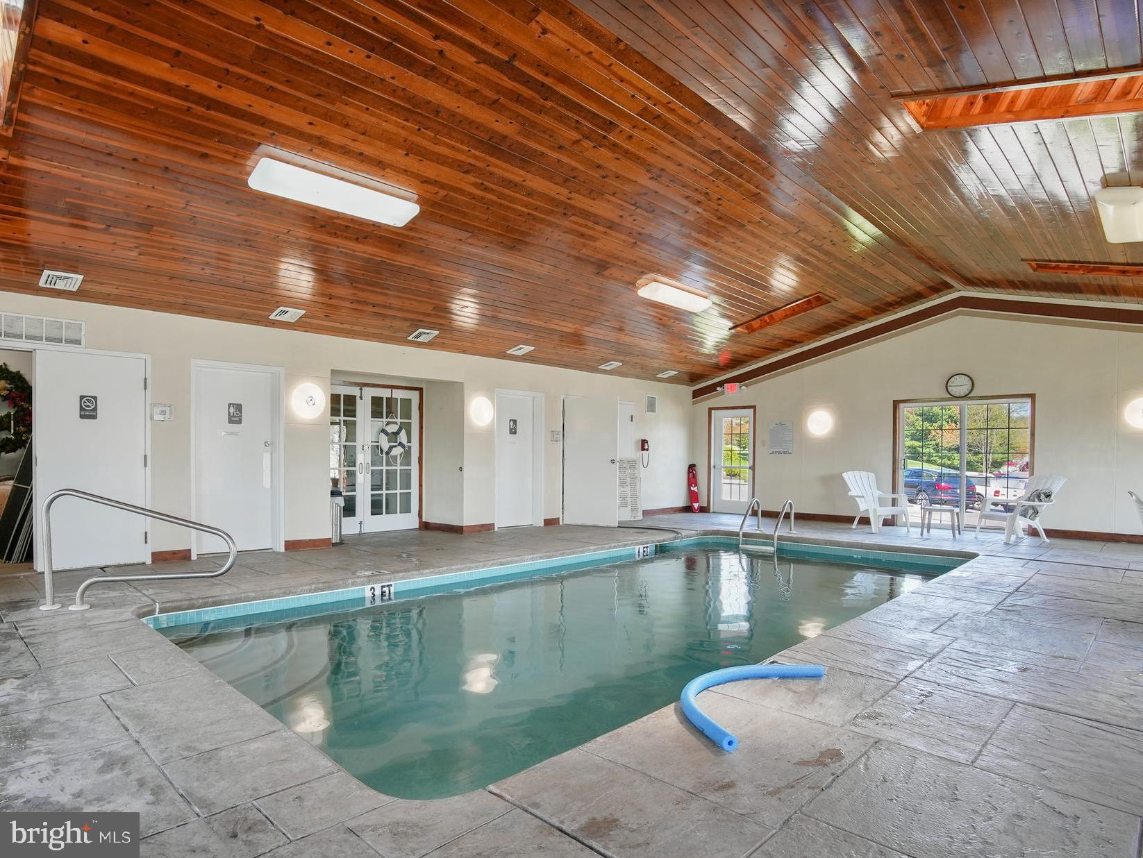 223 Brandon Road Eagleville, PA 19403 - Photo 36 of 38 a swimming pool with outdoor seating