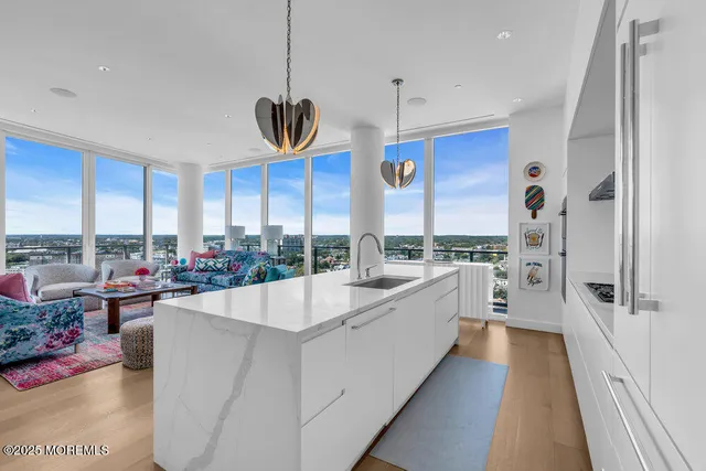 a living room with furniture and a floor to ceiling window