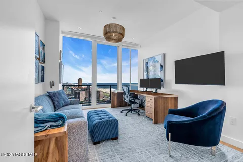 a spacious bedroom with a large bed and a flat screen tv