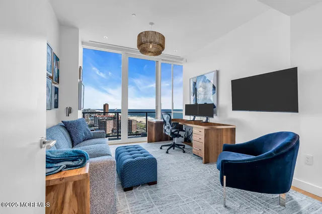 a spacious bedroom with a large bed and a flat screen tv