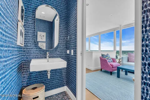 a bathroom with a sink toilet and shower curtain