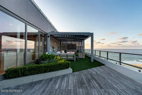 a view of a patio with table and chairs with a barbeque grill