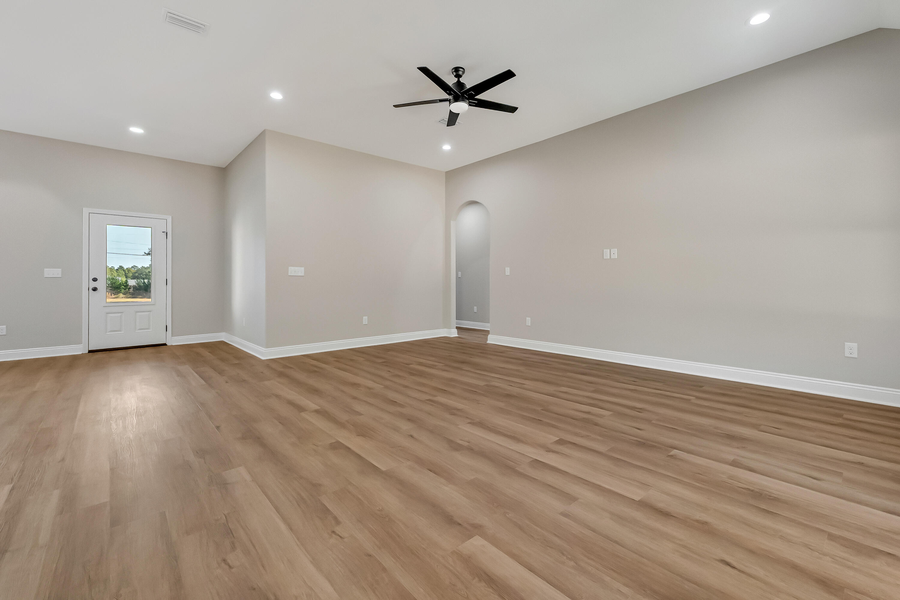 5840 Phillip Road Crestview, FL 32539 - Photo 13 of 59 an empty room with wooden floor and a ceiling fan
