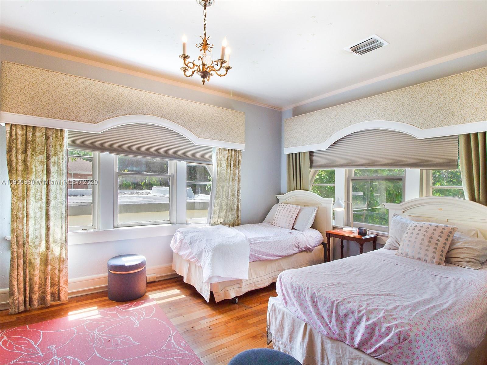 168 Northeast 44th Street Miami, FL 33137 - Photo 12 of 19 a bedroom with two beds and large windows