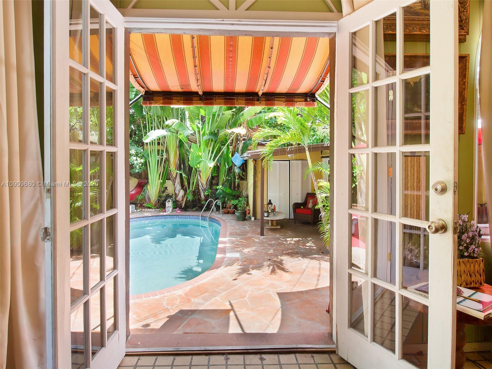 168 Northeast 44th Street Miami, FL 33137 - Photo 13 of 19 a view of a porch with a floor to ceiling window next to a yard