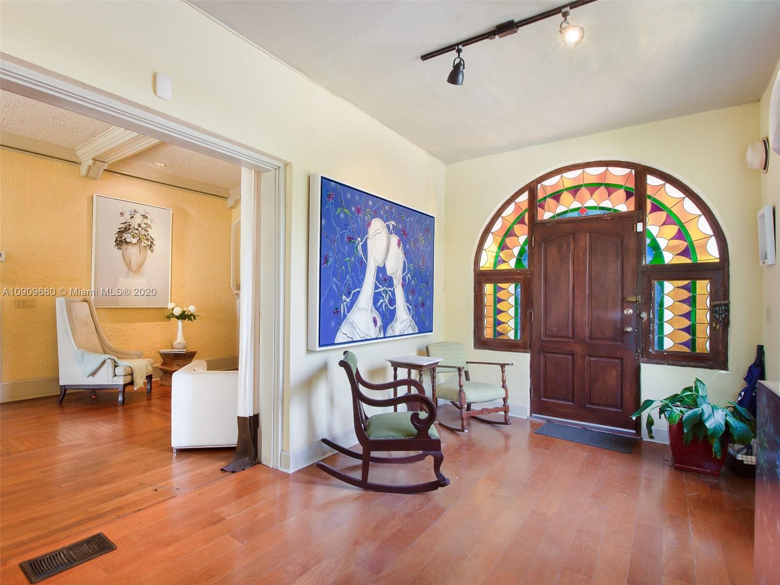 168 Northeast 44th Street Miami, FL 33137 - Photo 2 of 19 a living room with furniture and a painting on the wall