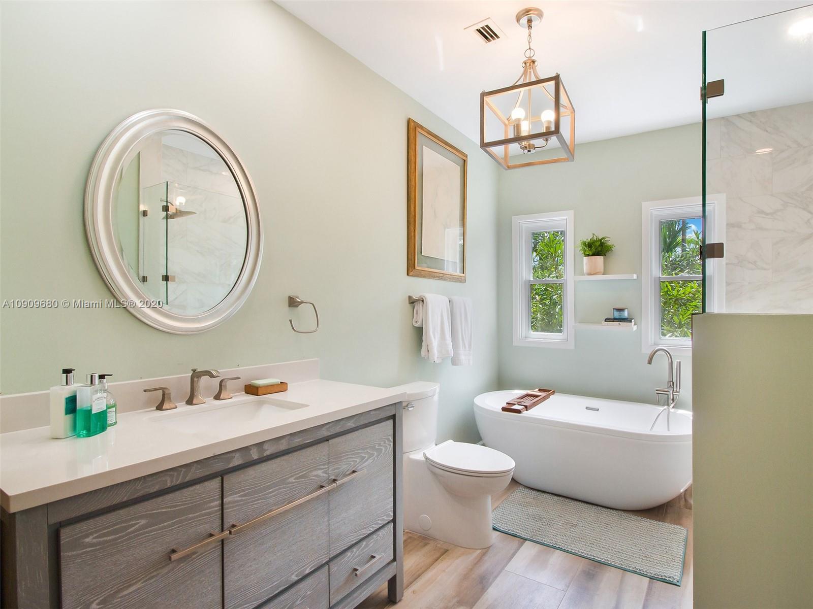 168 Northeast 44th Street Miami, FL 33137 - Photo 10 of 19 a bathroom with a toilet a sink and a mirror