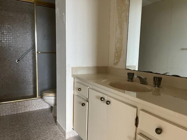3850 Washington Street, Unit 405 Hollywood, FL 33021 - Photo 13 of 14 a bathroom with a granite countertop sink toilet and shower