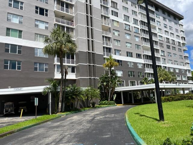 3850 Washington Street, Unit 405 Hollywood, FL 33021 - Photo 2 of 14 a front view of a building with garden