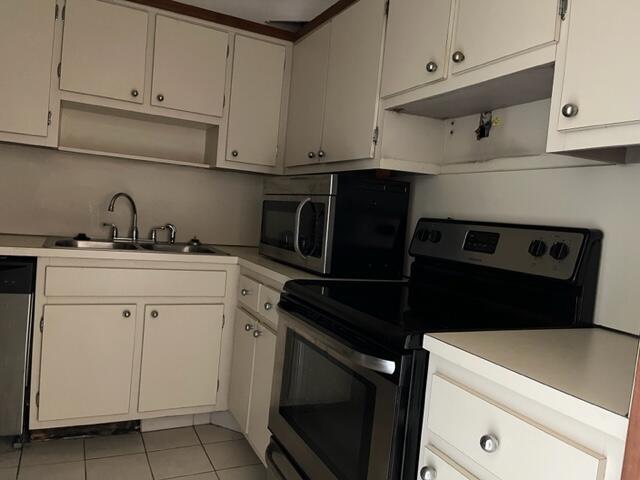 3850 Washington Street, Unit 405 Hollywood, FL 33021 - Photo 7 of 14 a kitchen with a sink and cabinets