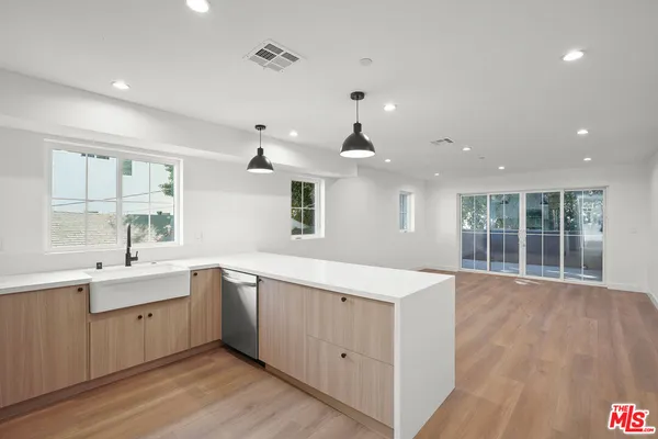 a large white kitchen with a large window